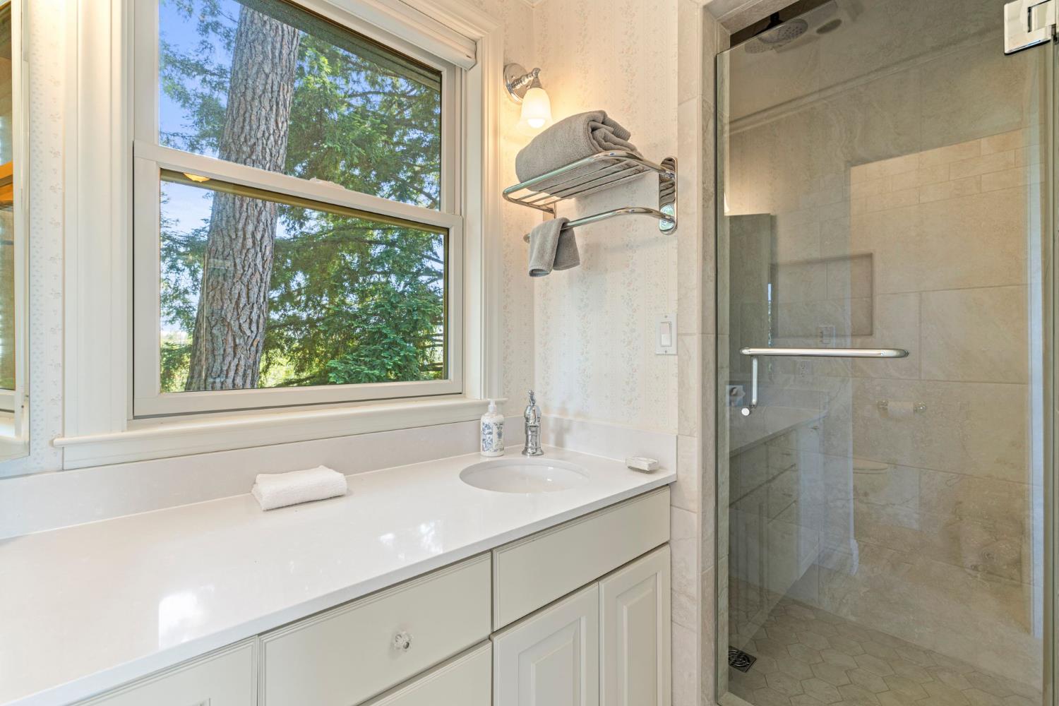 5821 Spanish Flat Road Placerville, CA 95667 - Photo 38 of 97 a bathroom with a granite countertop shower a sink and a mirror