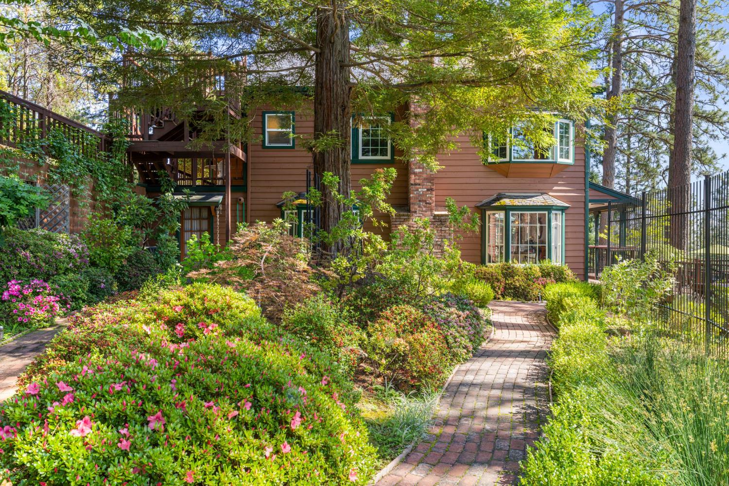 5821 Spanish Flat Road Placerville, CA 95667 - Photo 65 of 97 a front view of a house with a yard and fountain in middle