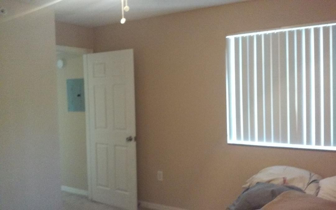 4171 Haverhill Road, Unit 1013 West Palm Beach, FL 33417 - Photo 14 of 14 a view of a bedroom with a bed and a window