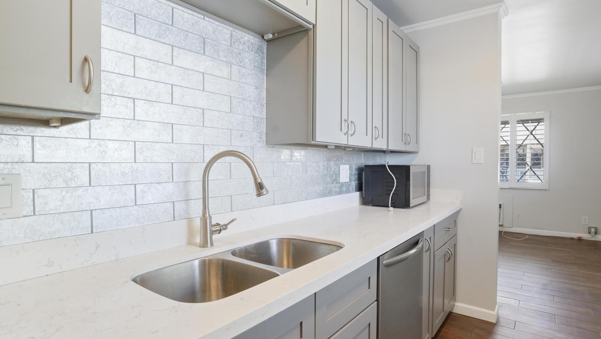 a close view of a sink and dishwasher in a kitchen