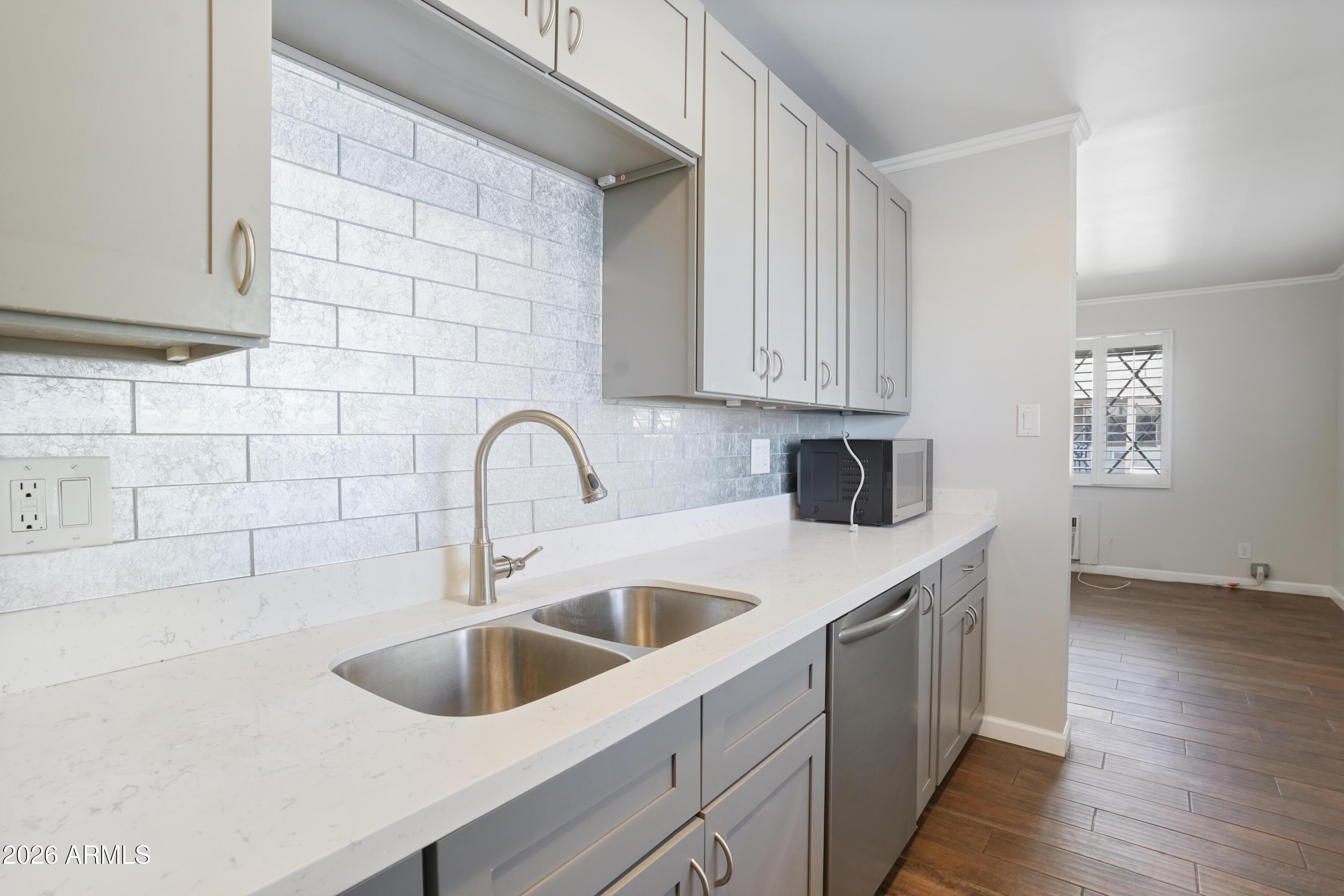 3426 North Miller Road, Unit 5 Scottsdale, AZ 85251 - Photo 3 of 11 a kitchen with stainless steel appliances a sink a stove and cabinets