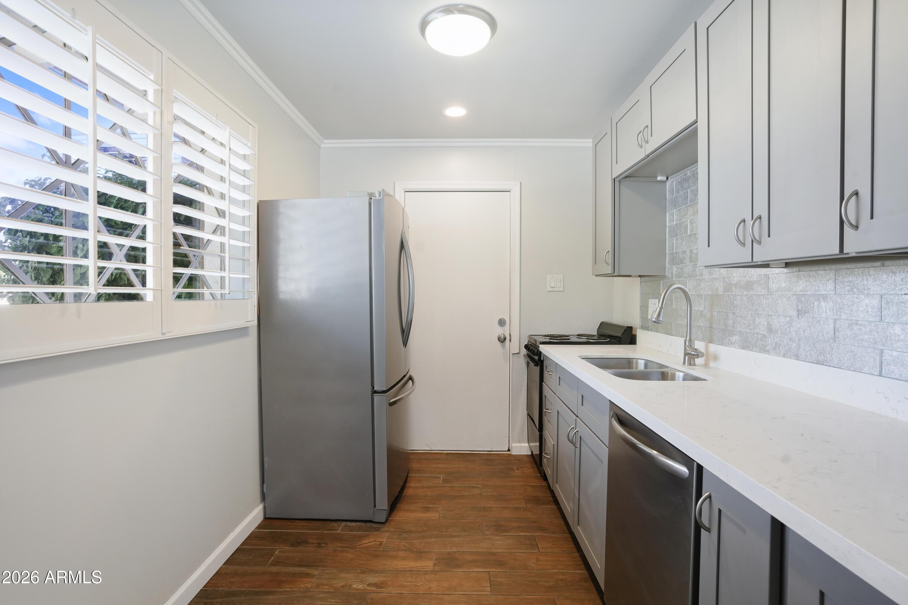 3426 North Miller Road, Unit 5 Scottsdale, AZ 85251 - Photo 4 of 11 a kitchen with a sink and refrigerator