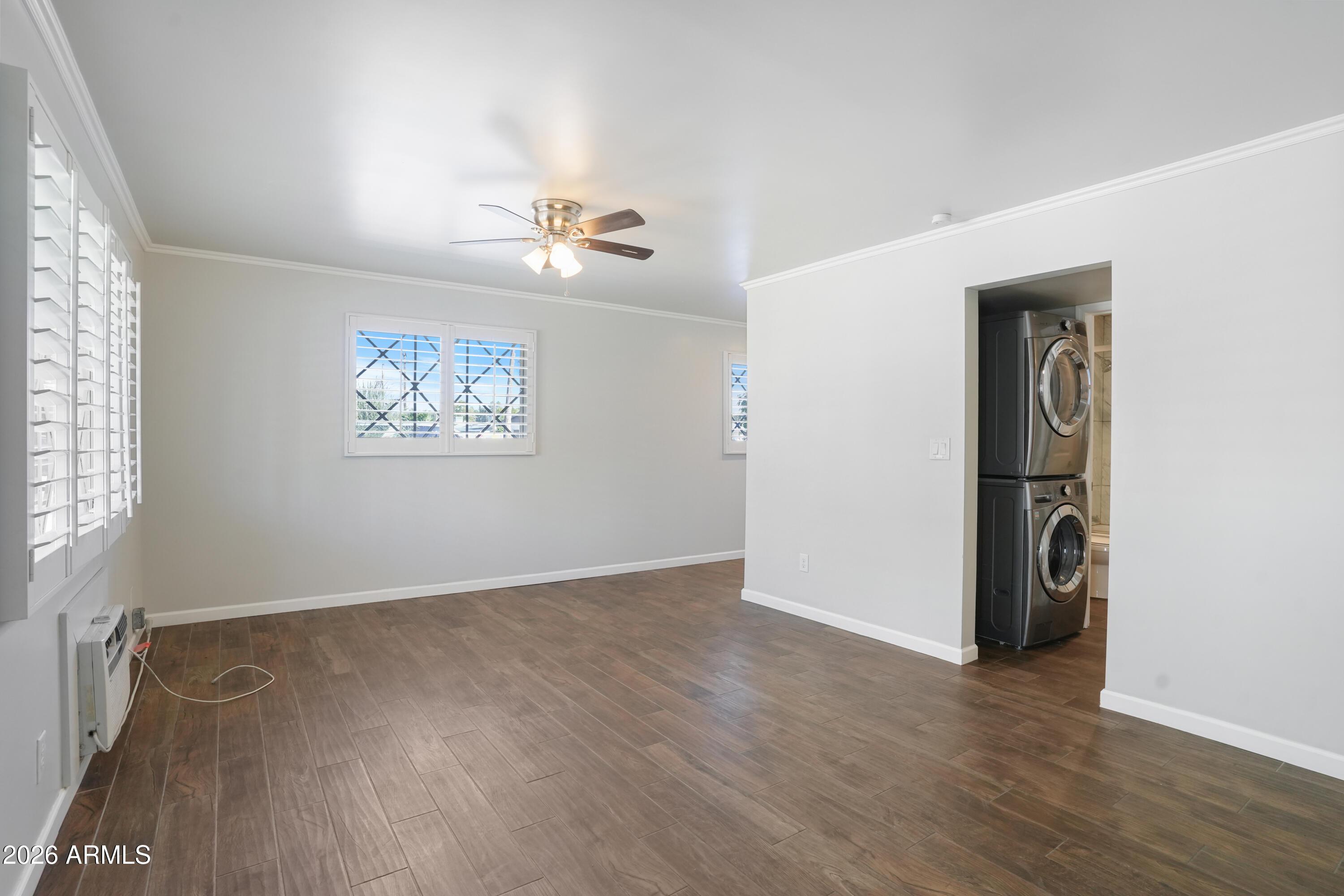 3426 North Miller Road, Unit 5 Scottsdale, AZ 85251 - Photo 5 of 11 an empty room with wooden floor chandelier and windows
