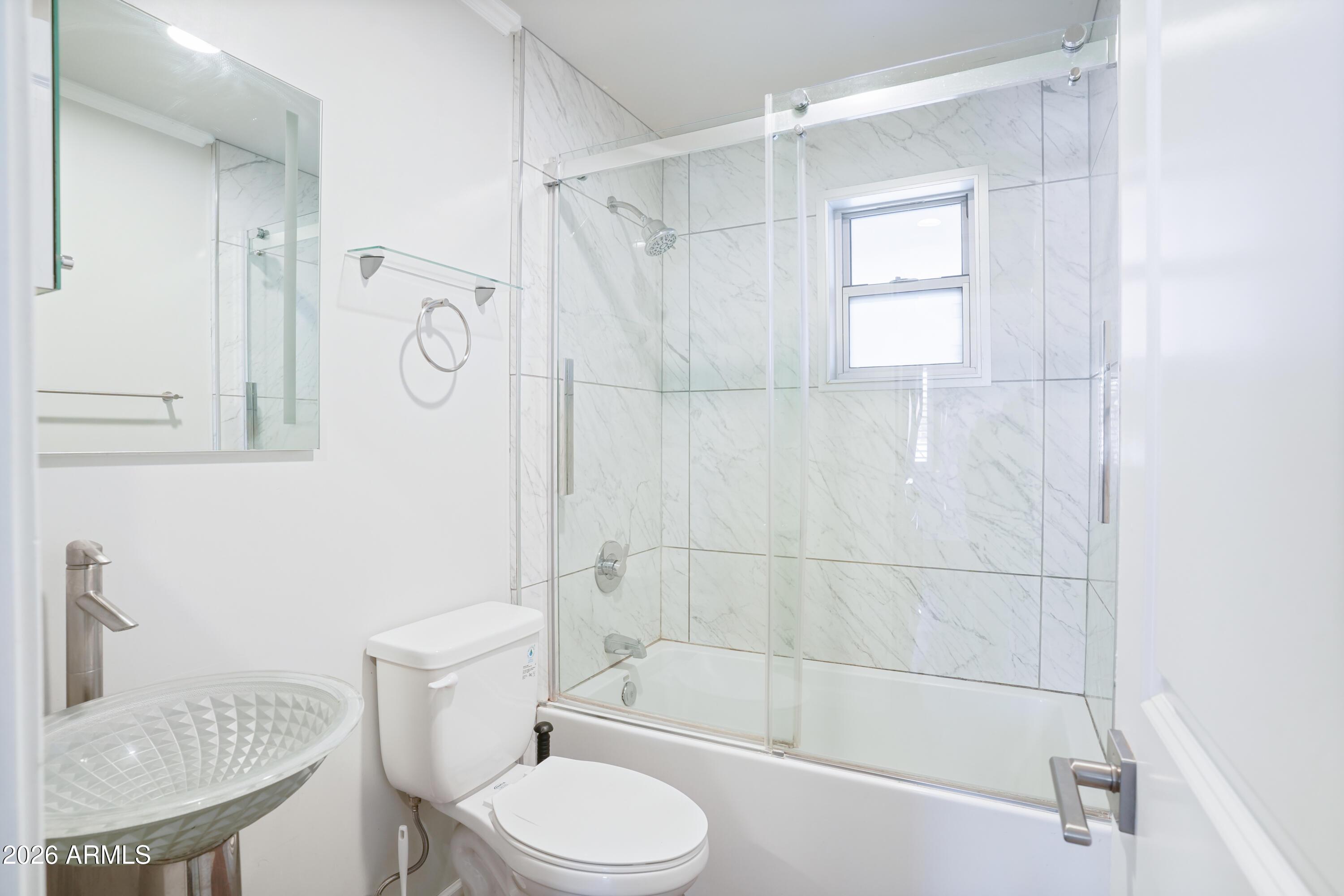 3426 North Miller Road, Unit 5 Scottsdale, AZ 85251 - Photo 7 of 11 a bathroom with a sink toilet and shower