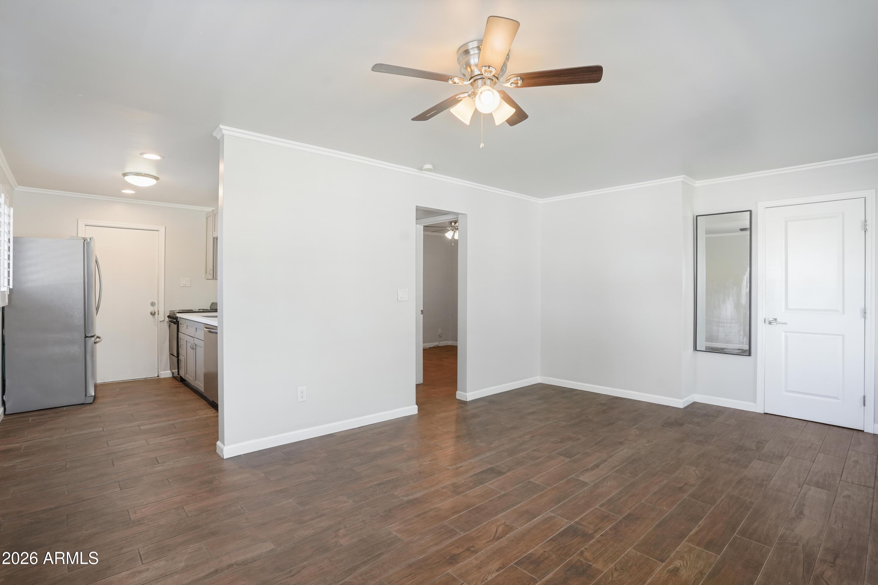 3426 North Miller Road, Unit 5 Scottsdale, AZ 85251 - Photo 9 of 11 a view of empty room with wooden floor