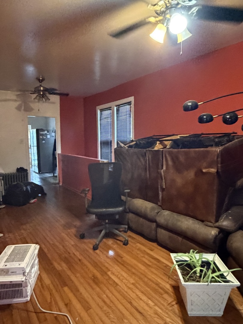 2057 West 70th Place Chicago, IL 60636 - Photo 4 of 8 a living room with furniture and a flat screen tv