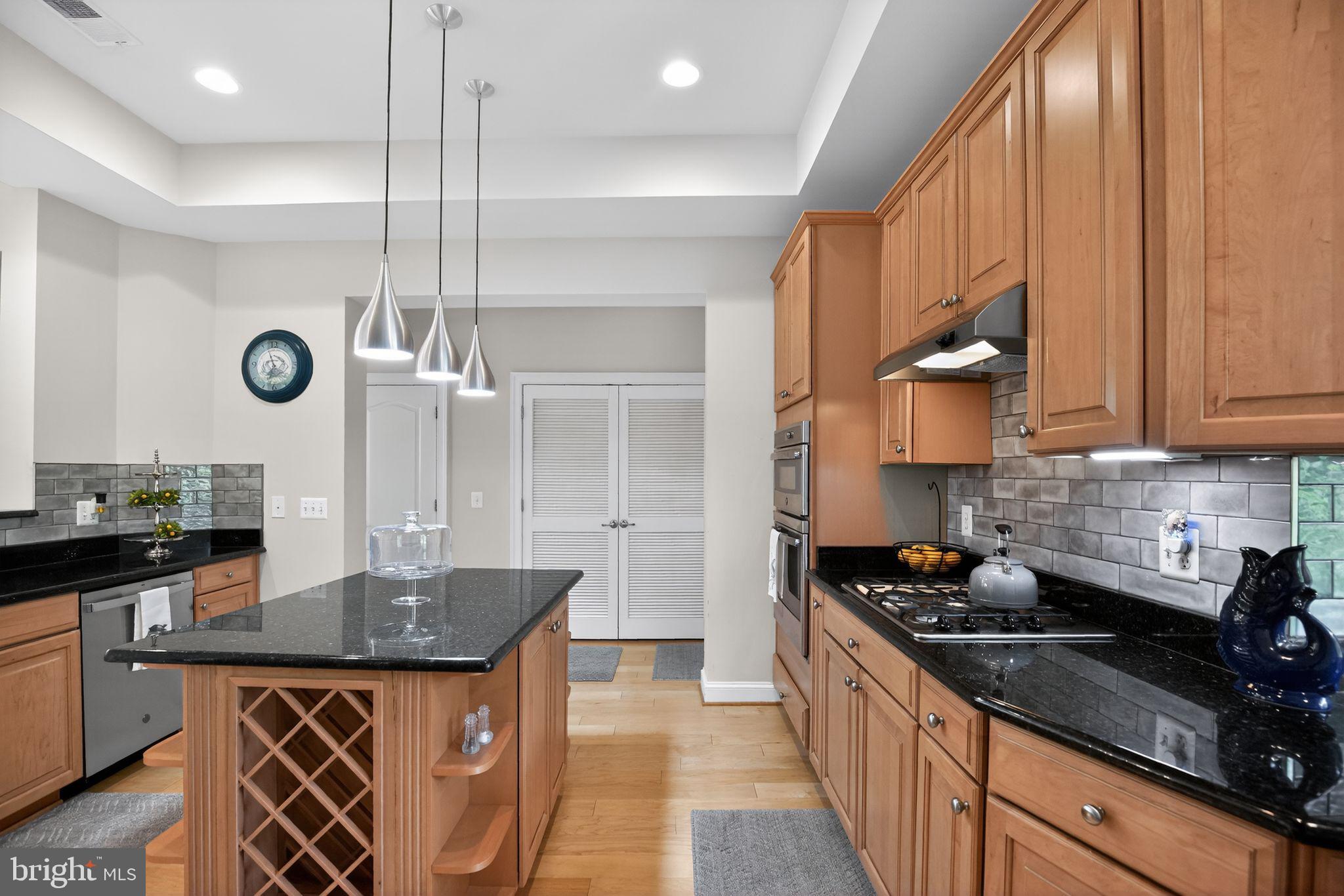 1331 Schooner Loop, Unit 1331 Solomons, MD 20688 - Photo 18 of 53 Kitchen island with wine rack