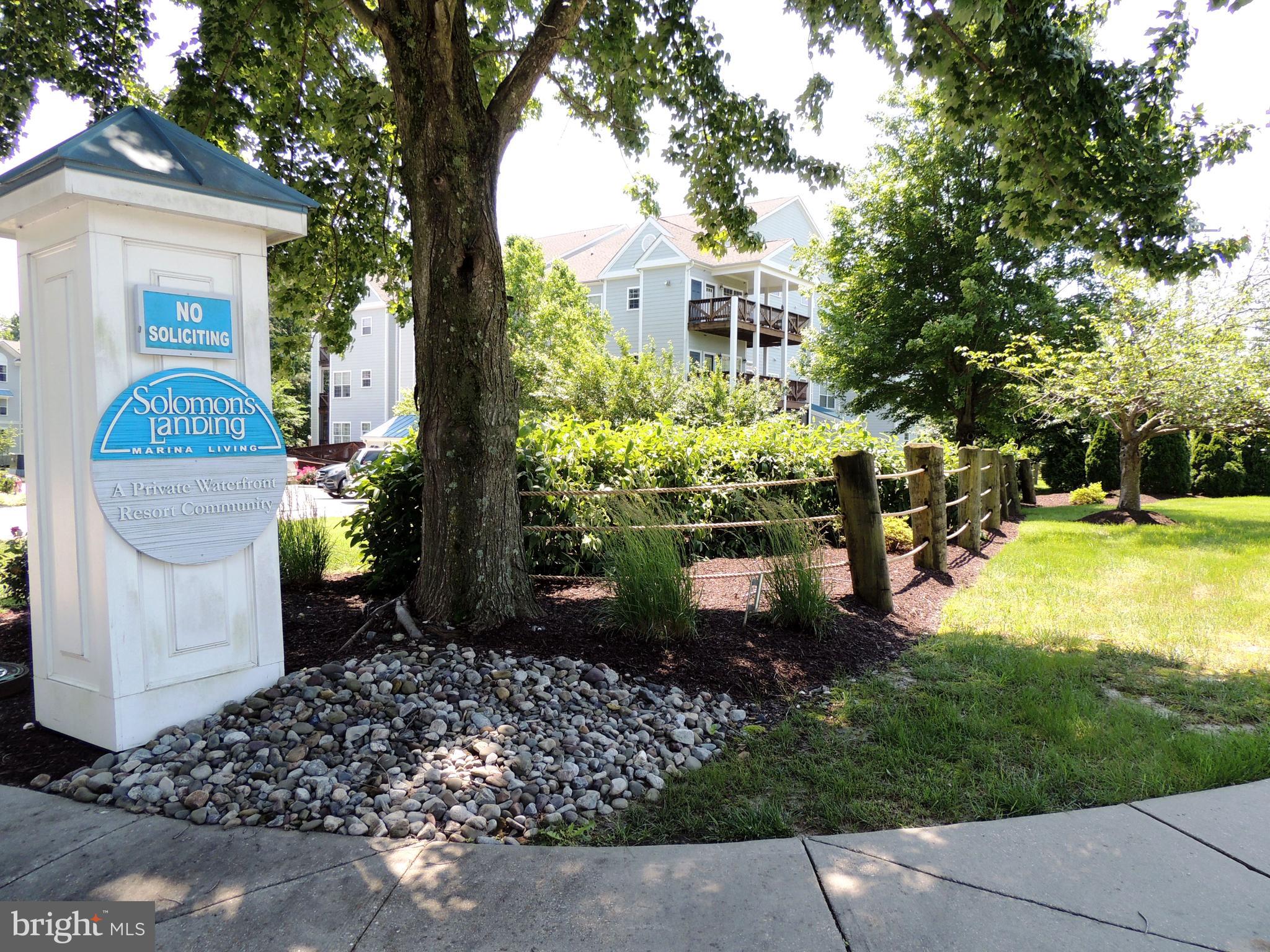 1331 Schooner Loop, Unit 1331 Solomons, MD 20688 - Photo 38 of 53 a front view of a house with a yard garage and outdoor seating