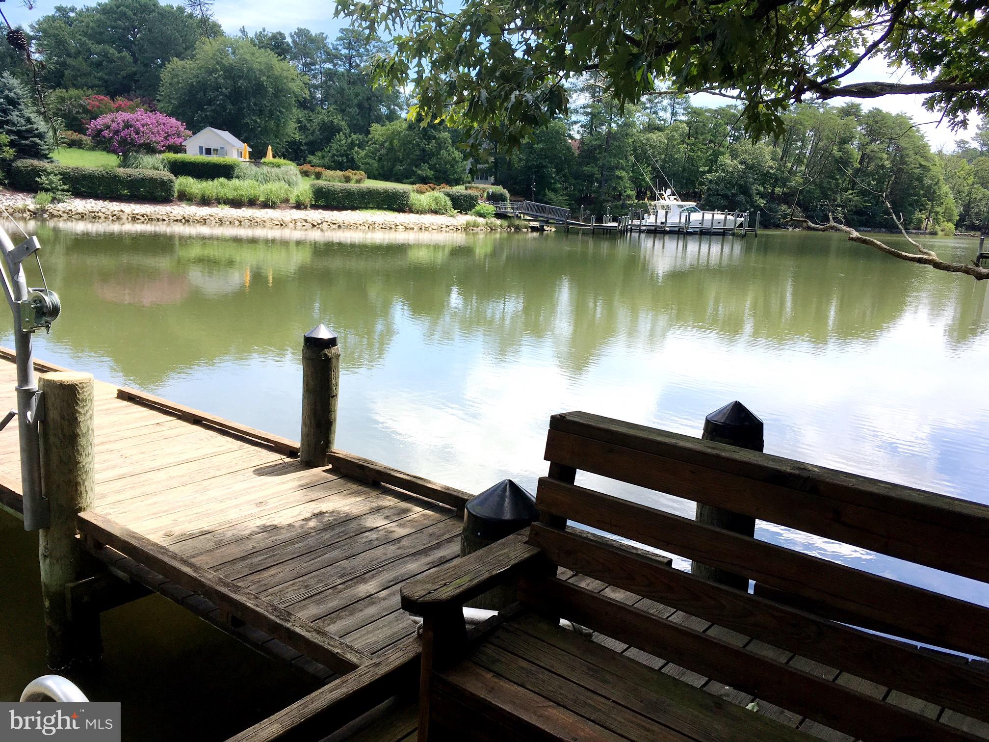 1331 Schooner Loop, Unit 1331 Solomons, MD 20688 - Photo 50 of 53 a view of a lake with a bench