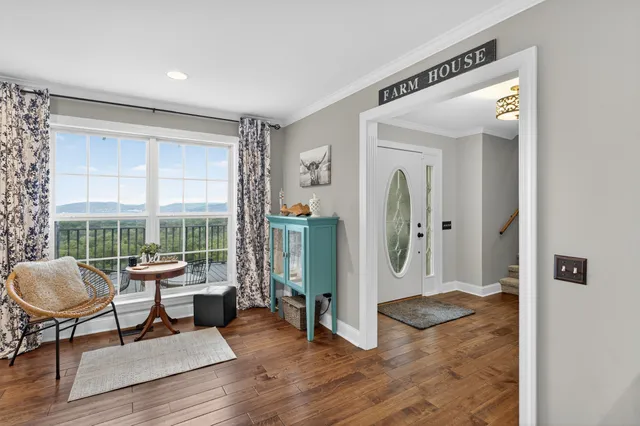 a view of a hallway with wooden floor and entryway