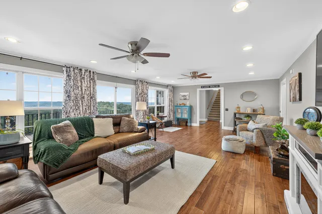 a view of a hallway with wooden floor and entryway