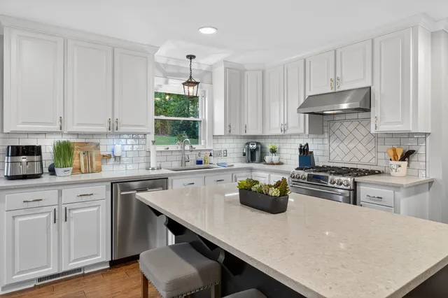a view of hallway with furniture and a window