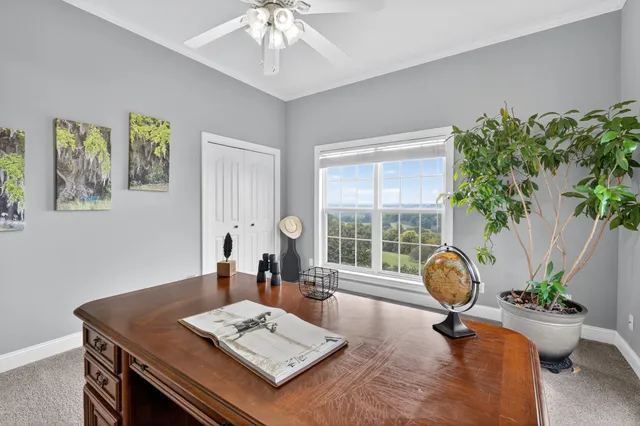 a view of a house with a big yard and sitting area