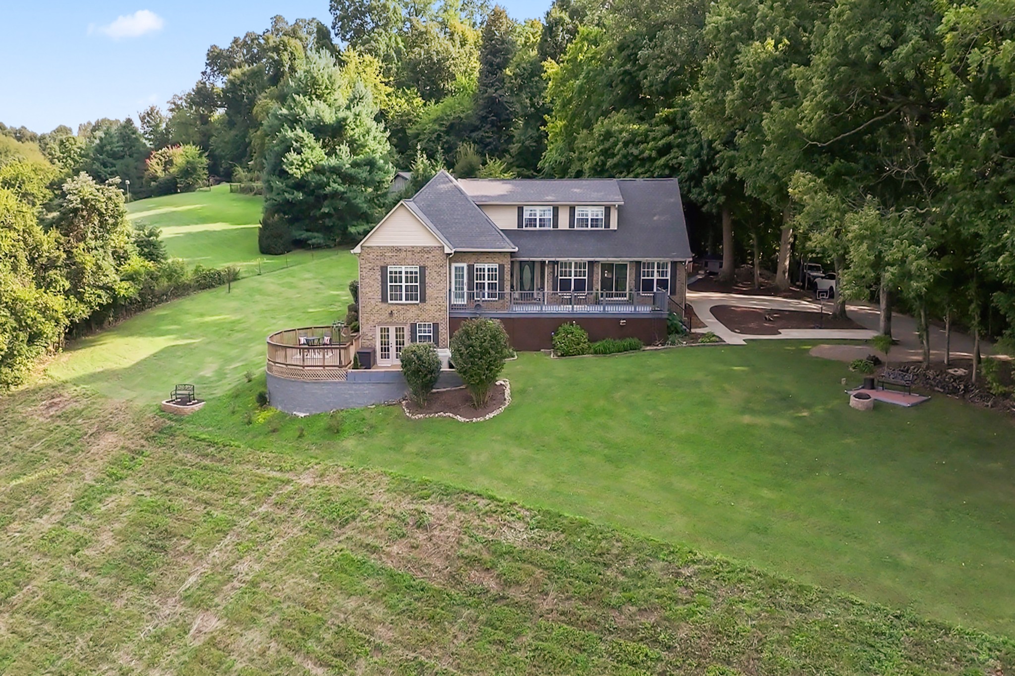 915 Normandy Road Normandy, TN 37360 - Photo 86 of 100 a view of a house with a big yard potted plants and a large tree