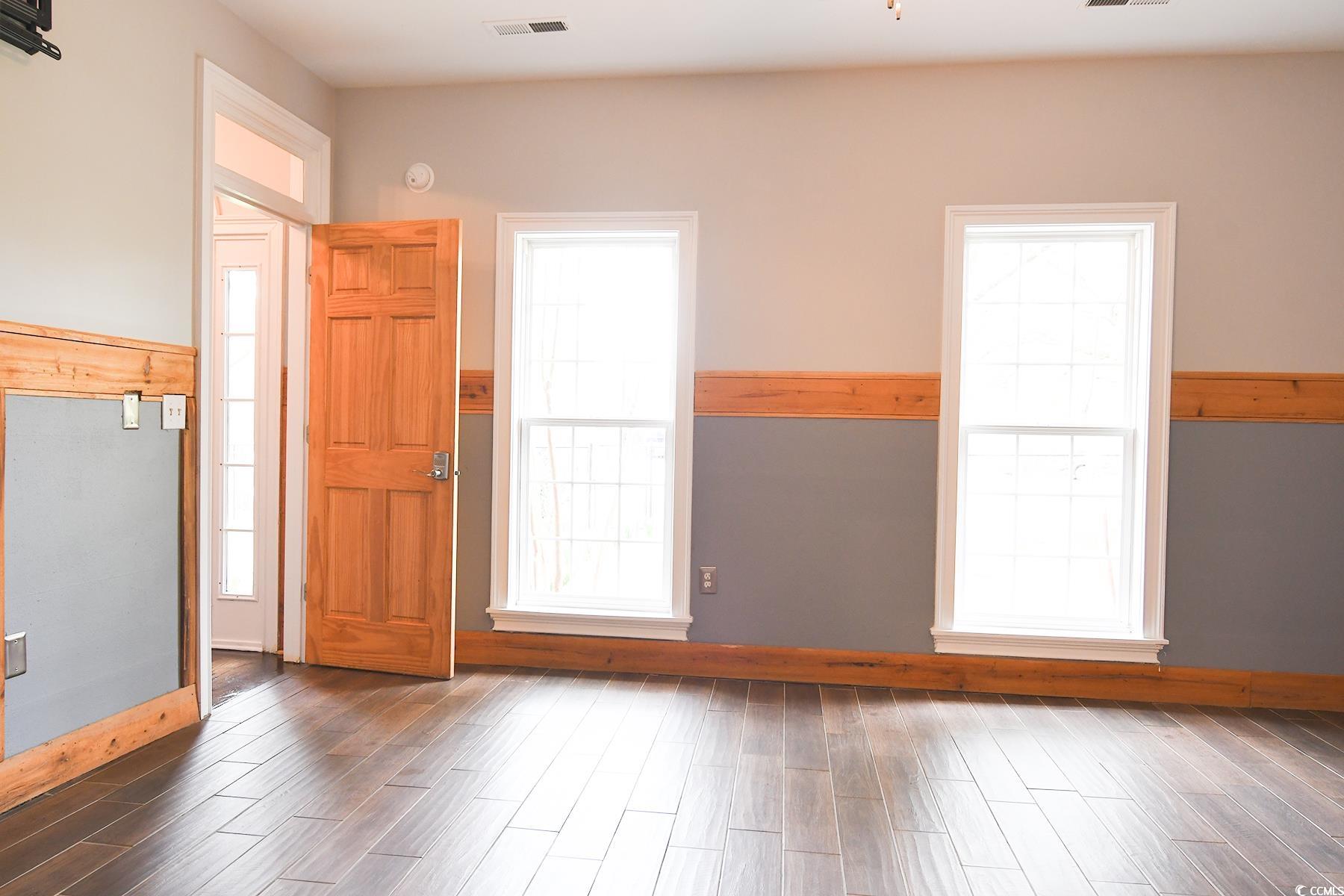 971 Folly Road Myrtle Beach, SC 29588 - Photo 11 of 25 Interior space featuring visible vents, baseboards, and wood finished floors