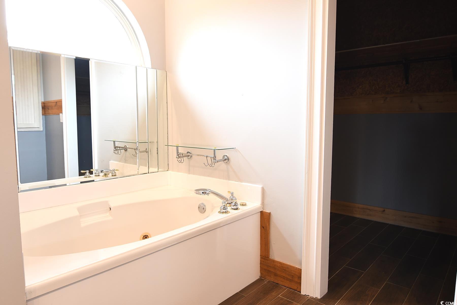 971 Folly Road Myrtle Beach, SC 29588 - Photo 12 of 25 Full bath featuring baseboards, a tub with jets, and wood finished floors