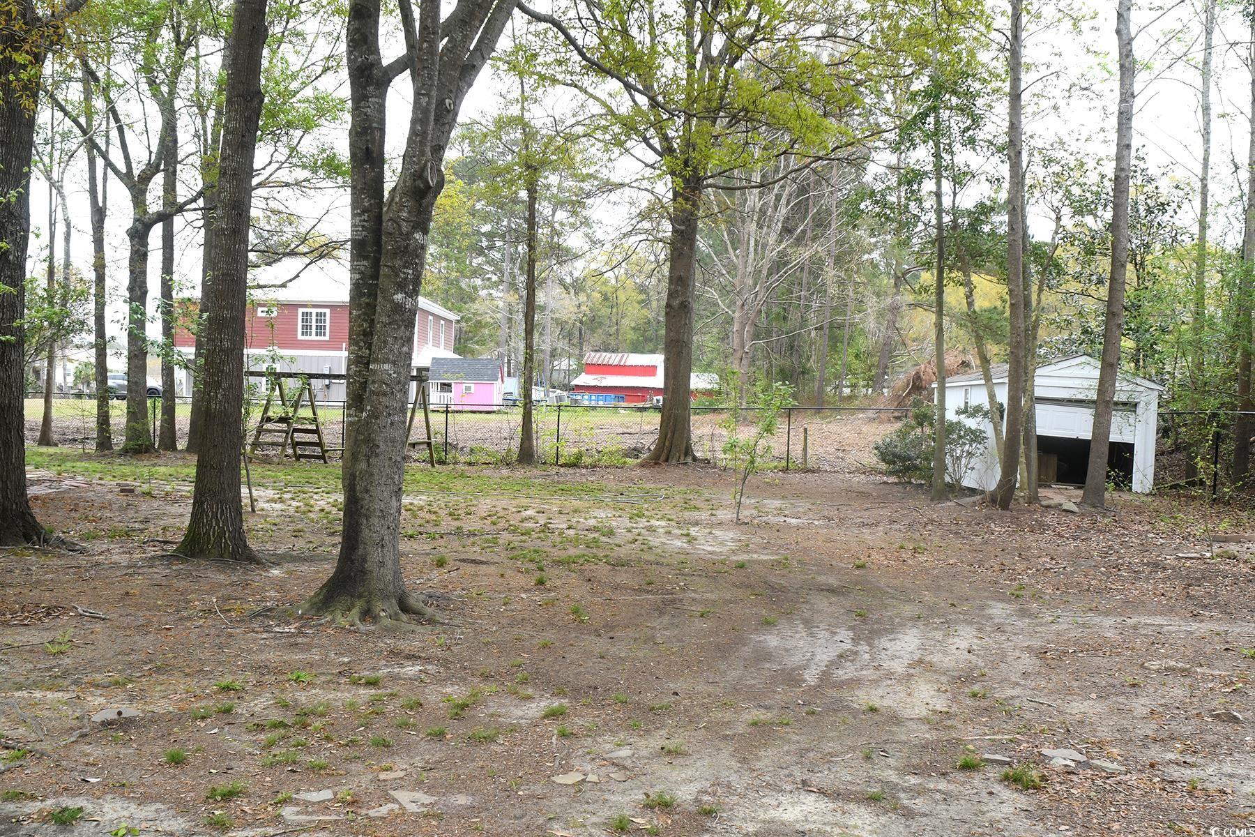 971 Folly Road Myrtle Beach, SC 29588 - Photo 24 of 25 View of yard with fence and an outbuilding
