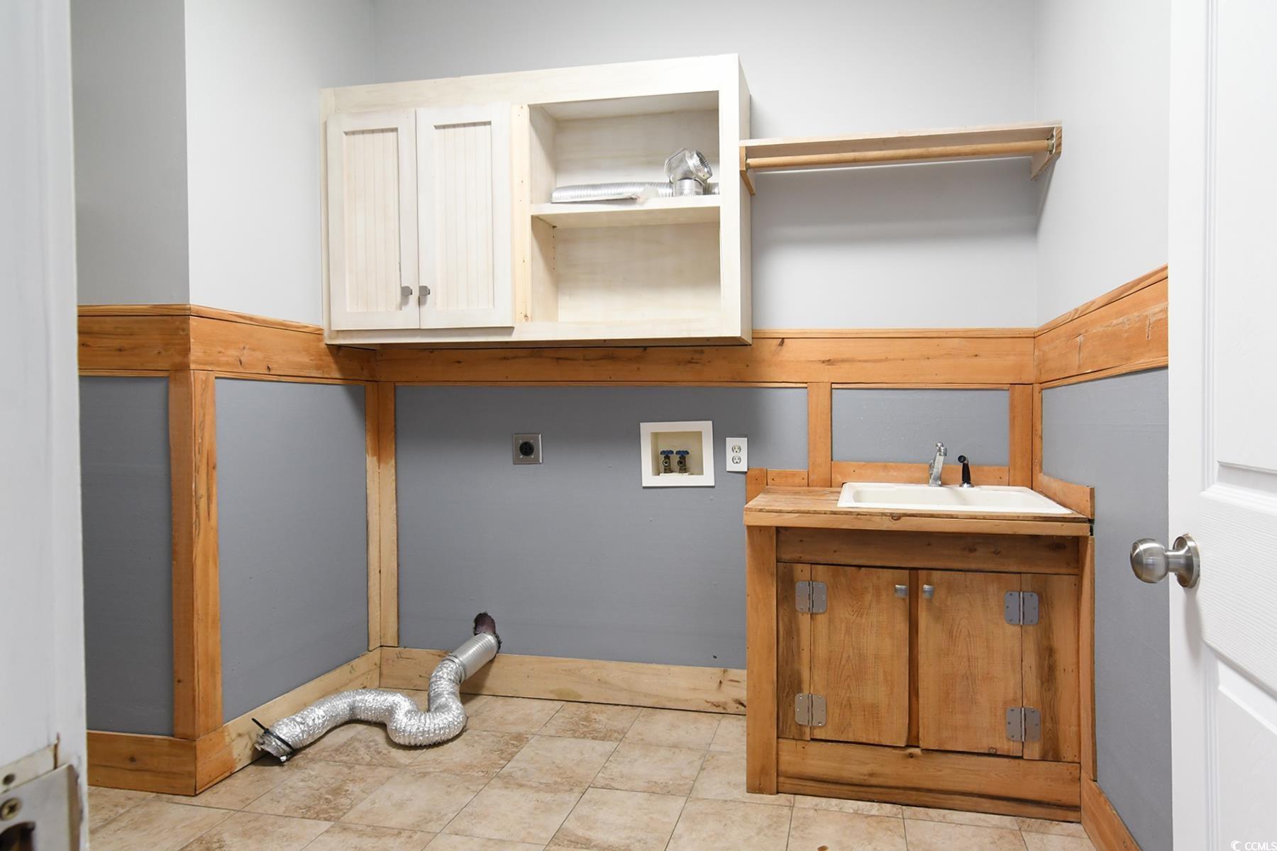 971 Folly Road Myrtle Beach, SC 29588 - Photo 5 of 25 Clothes washing area featuring hookup for an electric dryer, a sink, hookup for a washing machine, and cabinet space