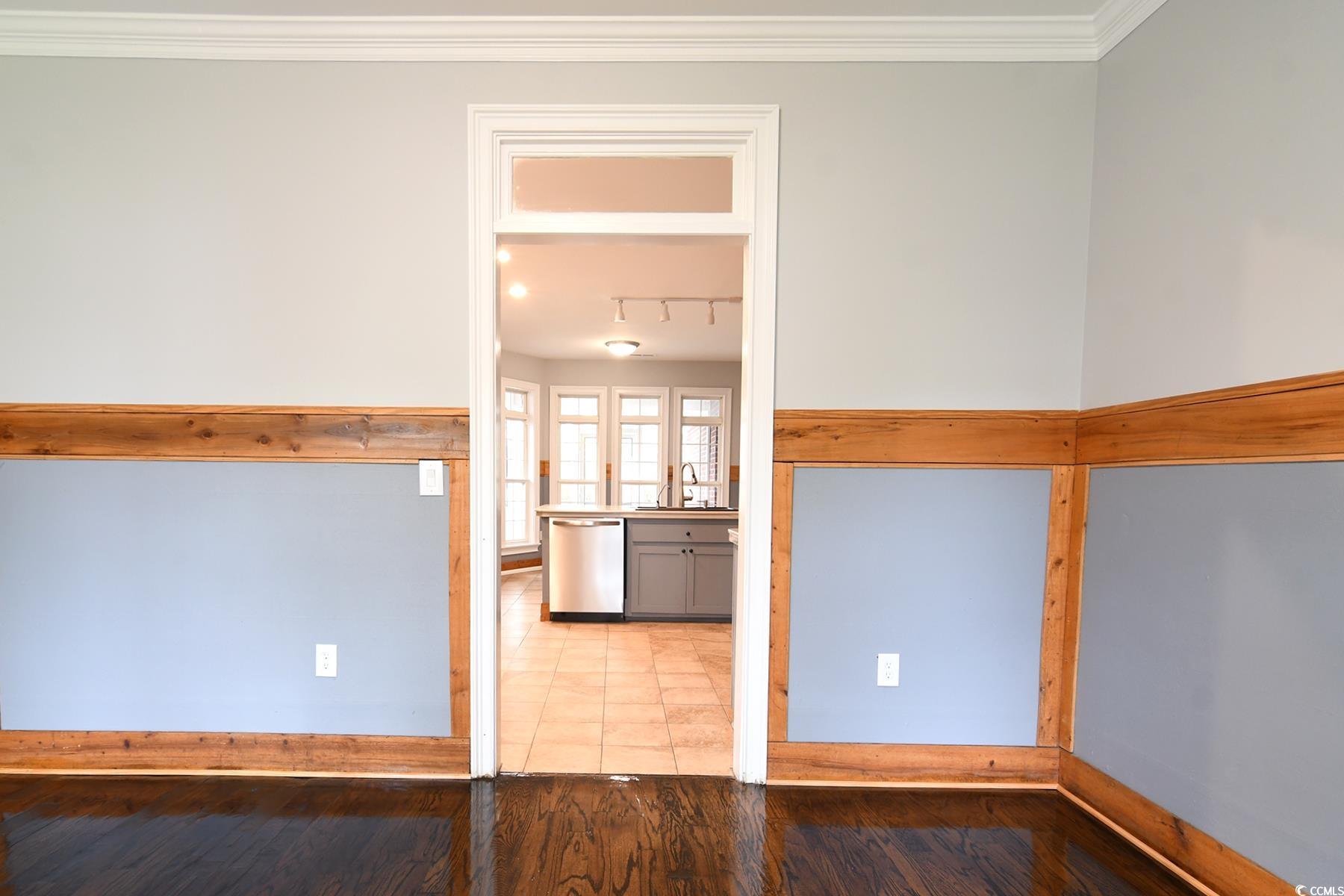 971 Folly Road Myrtle Beach, SC 29588 - Photo 6 of 25 Interior space featuring a sink, ornamental molding, baseboards, and wood finished floors