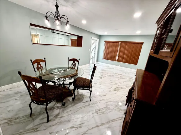 a view of a dining room with furniture wooden floor and chandelier