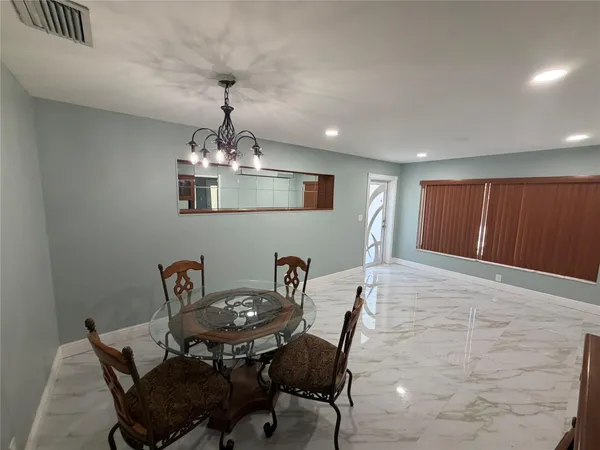 a dining room with furniture and chandelier