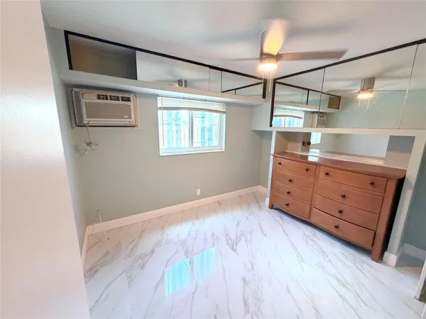 a room with a dresser and a window