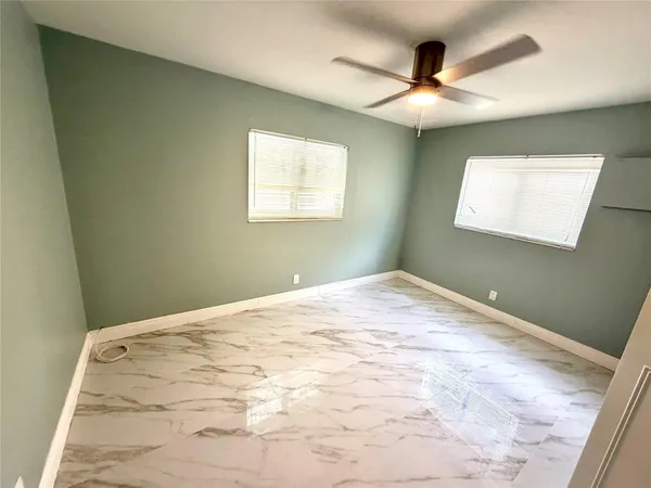 a view of a room with a ceiling fan