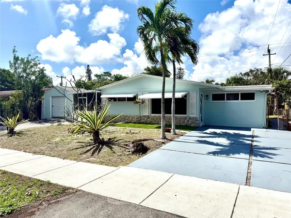 a palm tree sitting in front of a house
