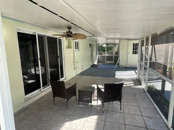 a view of a patio with table and chairs