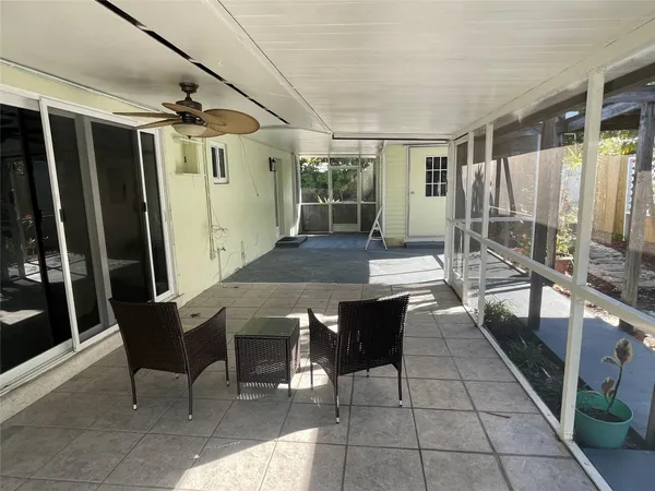 a view of a patio with table and chairs