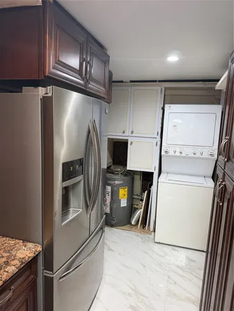 a kitchen with a refrigerator and a stove top oven