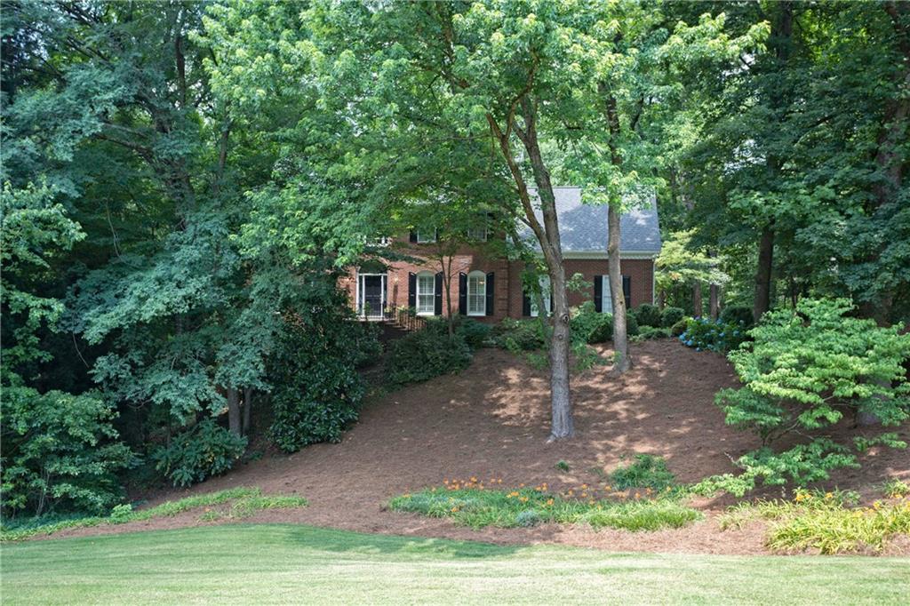 995 Riverside Trace Northwest Atlanta, GA 30328 - Photo 1 of 1 a house view with a garden space