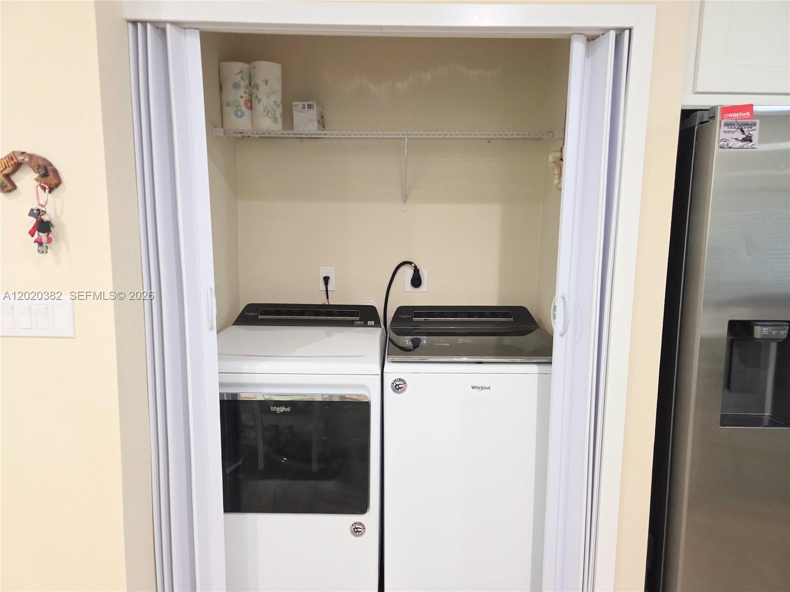 11 Pompano Avenue, Unit 11 Key Largo, FL 33037 - Photo 13 of 15 a close view of a utility room with dryer and washer