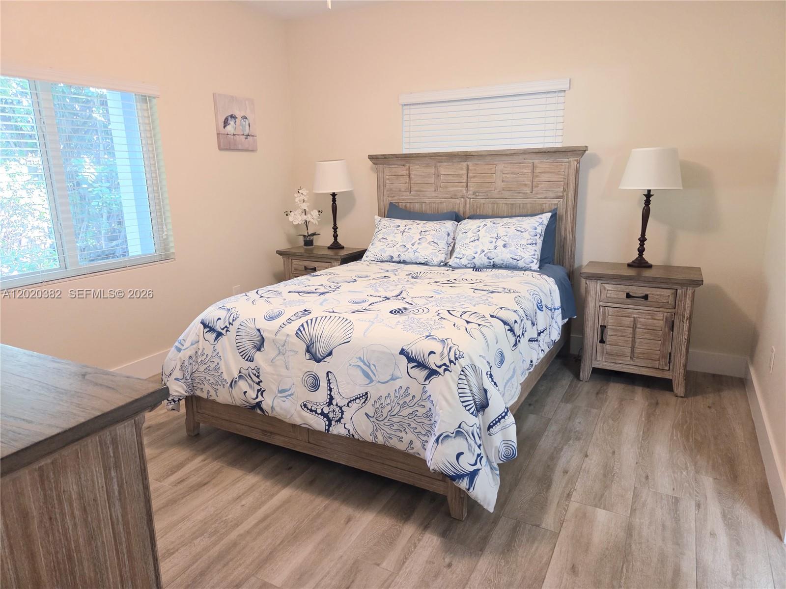 11 Pompano Avenue, Unit 11 Key Largo, FL 33037 - Photo 6 of 15 a bedroom with a bed and wooden floor