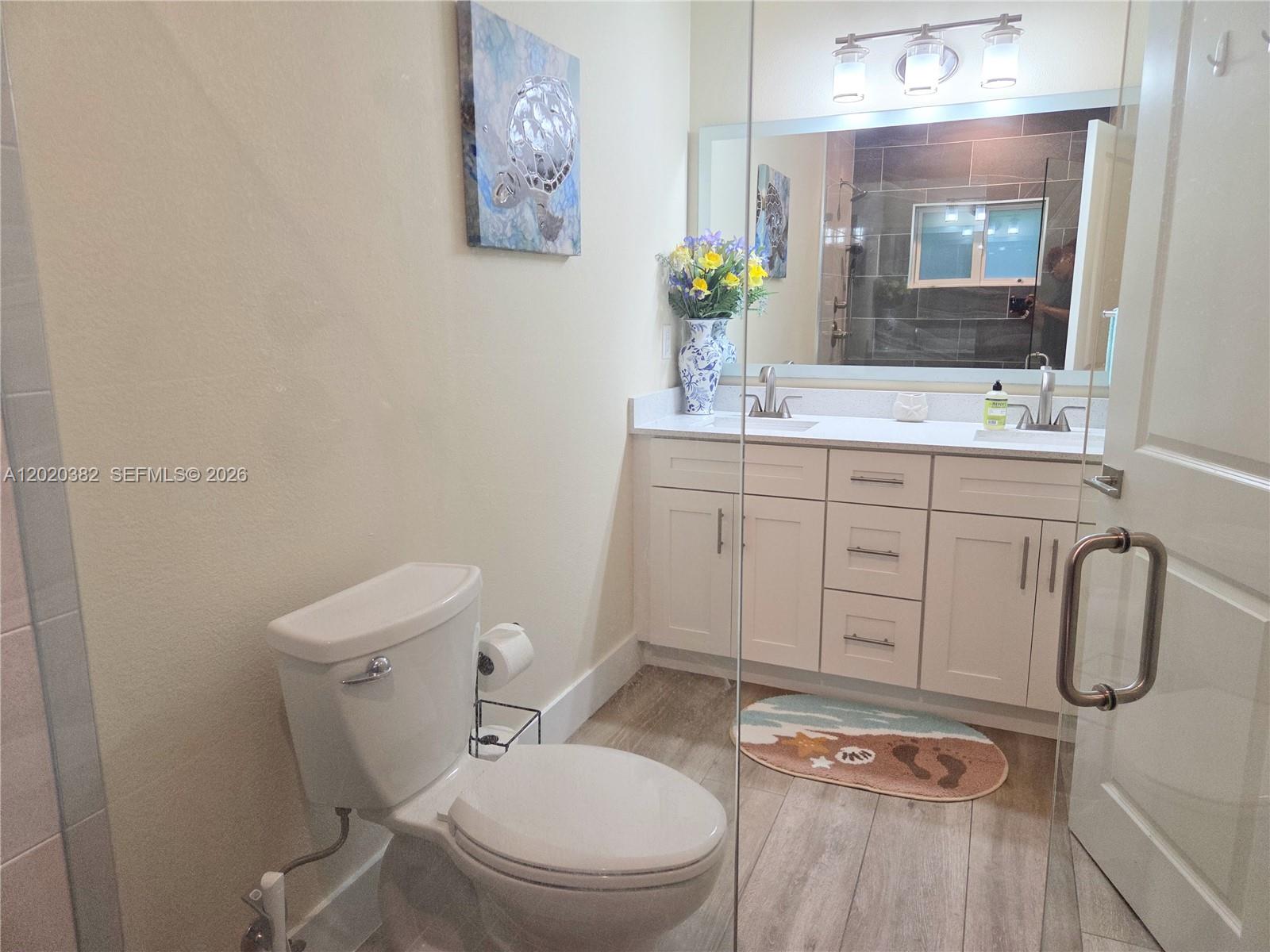 11 Pompano Avenue, Unit 11 Key Largo, FL 33037 - Photo 9 of 15 a bathroom with a granite countertop toilet sink and mirror
