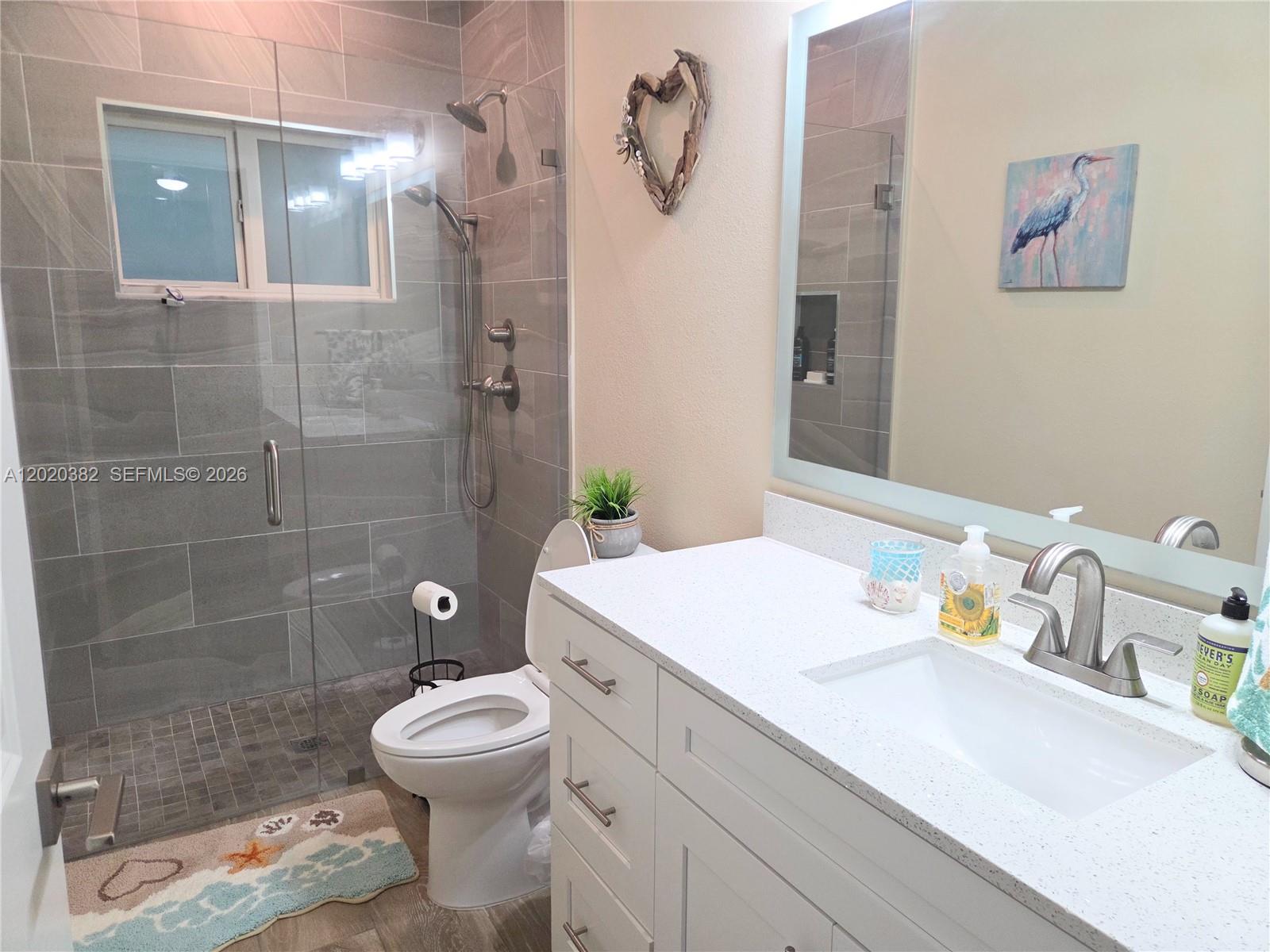 11 Pompano Avenue, Unit 11 Key Largo, FL 33037 - Photo 10 of 15 a bathroom with a sink toilet and shower
