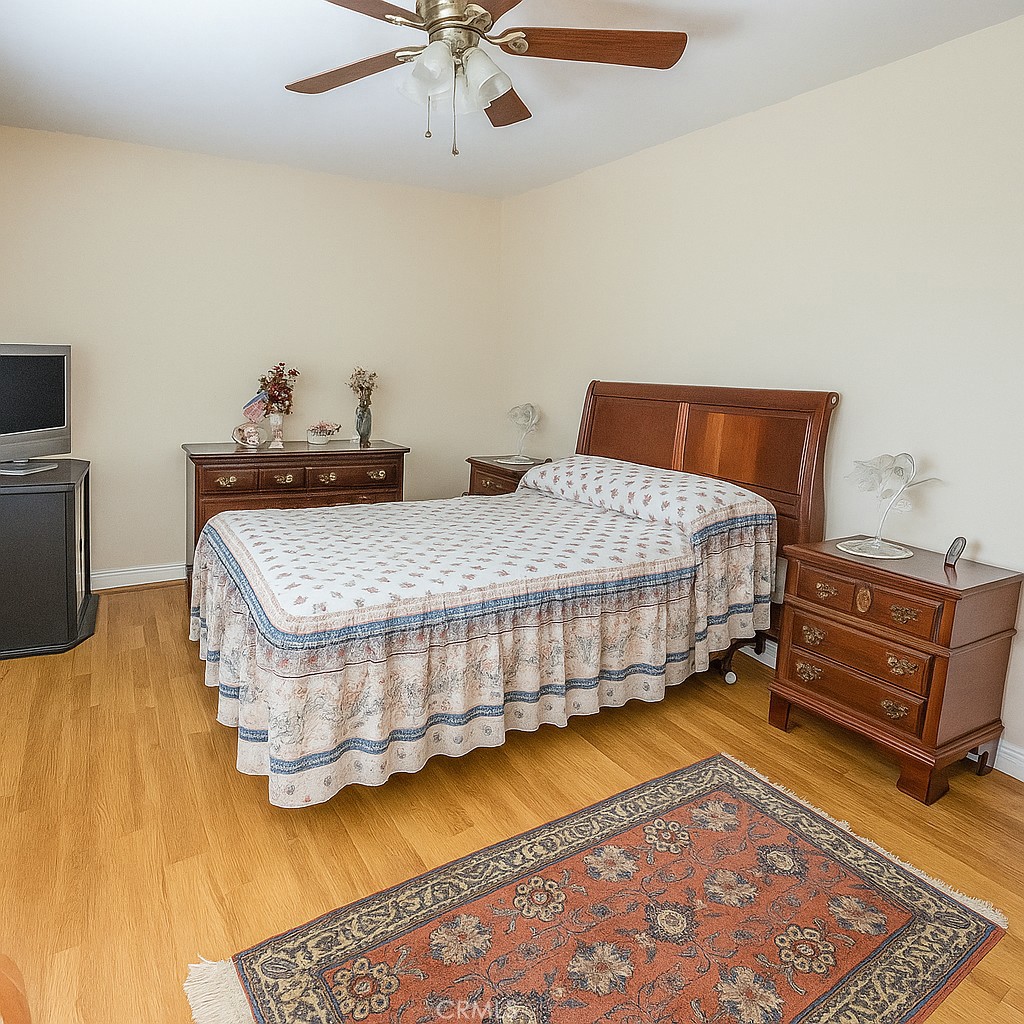25463 Hardy Place Stevenson Ranch, CA 91381 - Photo 13 of 21 a bedroom with a bed and wooden floor