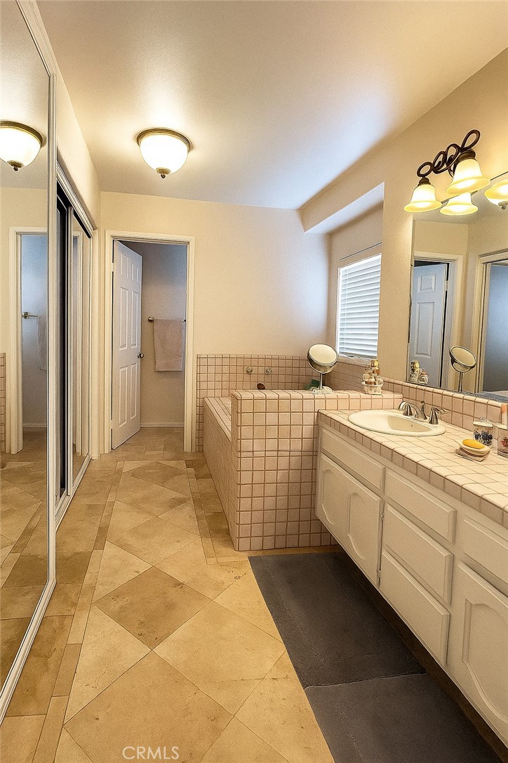 25463 Hardy Place Stevenson Ranch, CA 91381 - Photo 15 of 21 a spacious bathroom with a double vanity sink mirror and