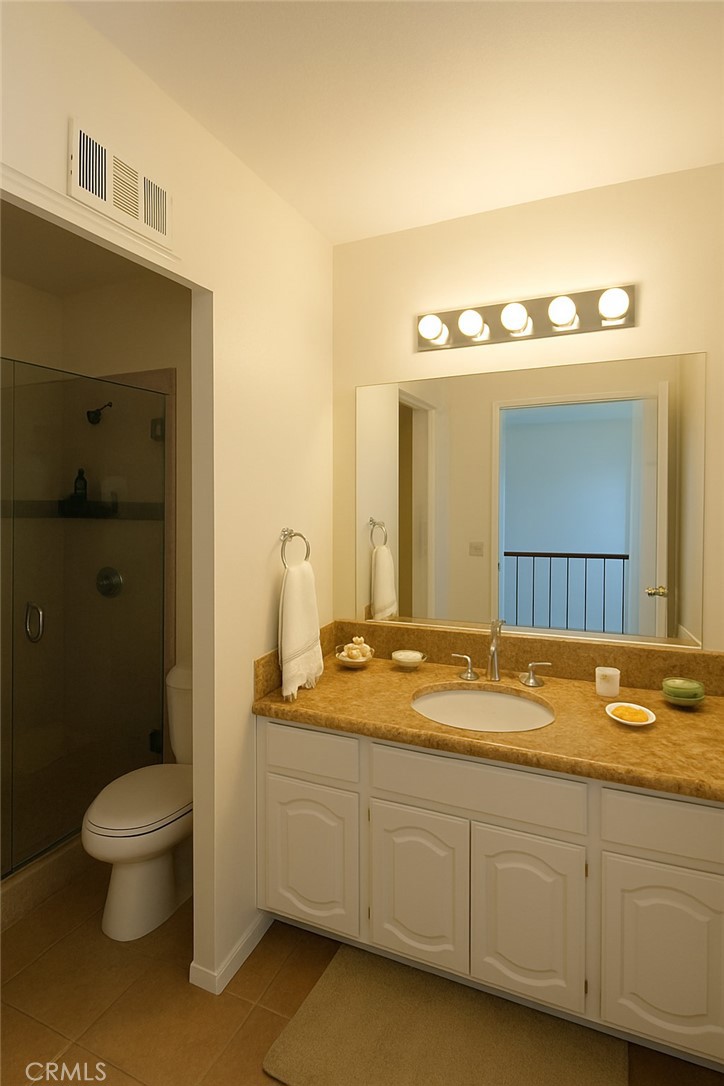 25463 Hardy Place Stevenson Ranch, CA 91381 - Photo 19 of 21 a bathroom with a granite countertop sink and a mirror