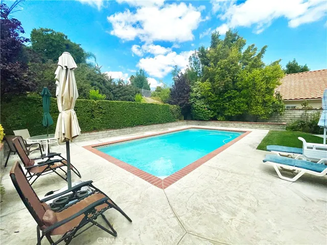 a view of a swimming pool with a lounge chairs