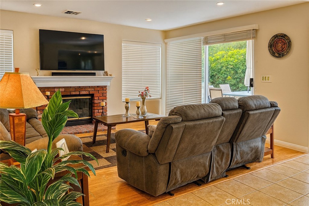 25463 Hardy Place Stevenson Ranch, CA 91381 - Photo 5 of 21 a living room with furniture a flat screen tv and a fireplace