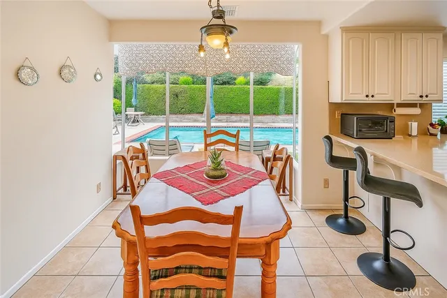 a view of a dining room with furniture and chandelier