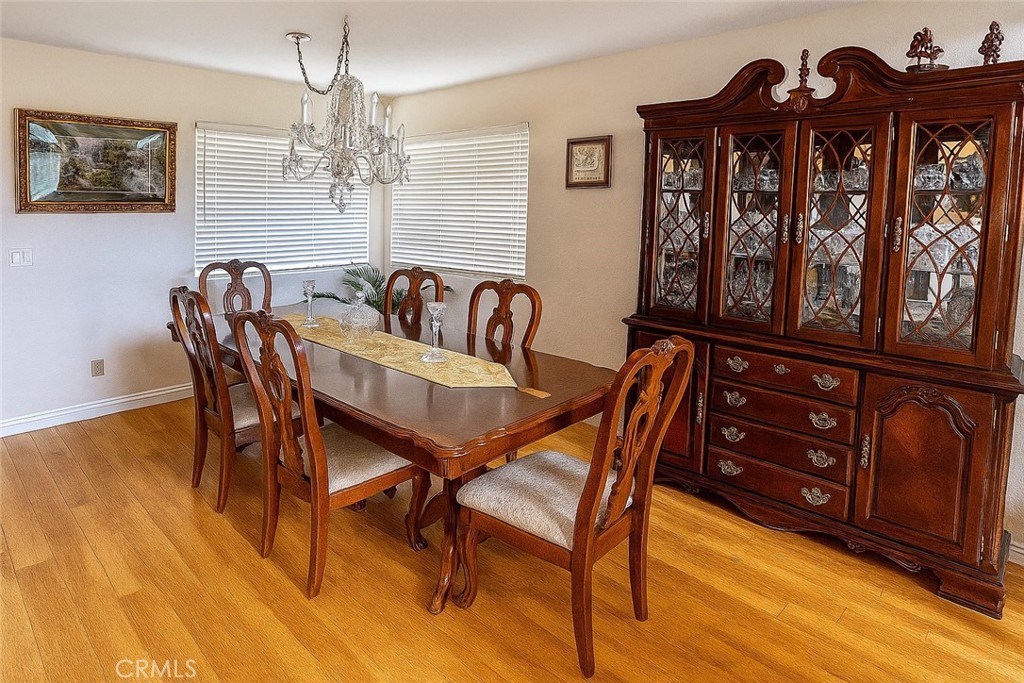 25463 Hardy Place Stevenson Ranch, CA 91381 - Photo 8 of 21 a view of a dining room with furniture chandelier and wooden floor