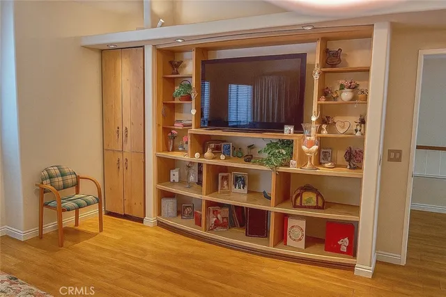 a view of front door with hallway and wooden floor