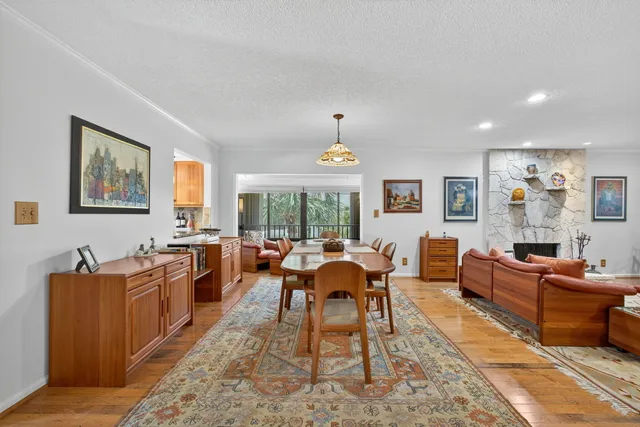 a dining room with wooden floor and a chandelier