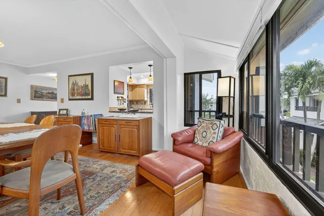 a living room with furniture a flat screen tv and a large window