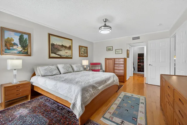 a bedroom with a bed a couch and dresser