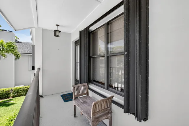a view of a hallway and a livingroom with furniture