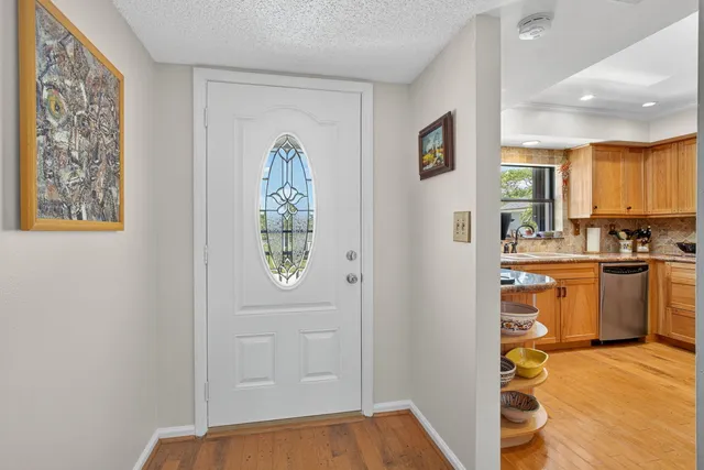 a kitchen with stainless steel appliances granite countertop a sink and cabinets