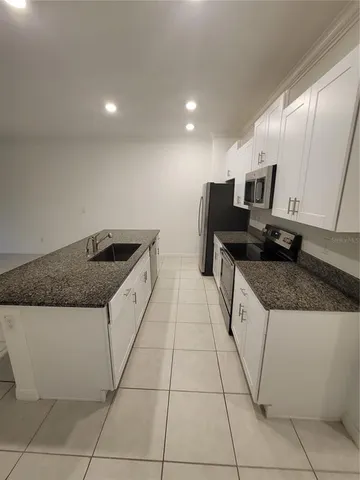 a kitchen with a sink and cabinets